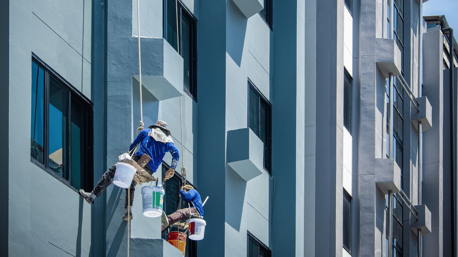 men painting outside of a building