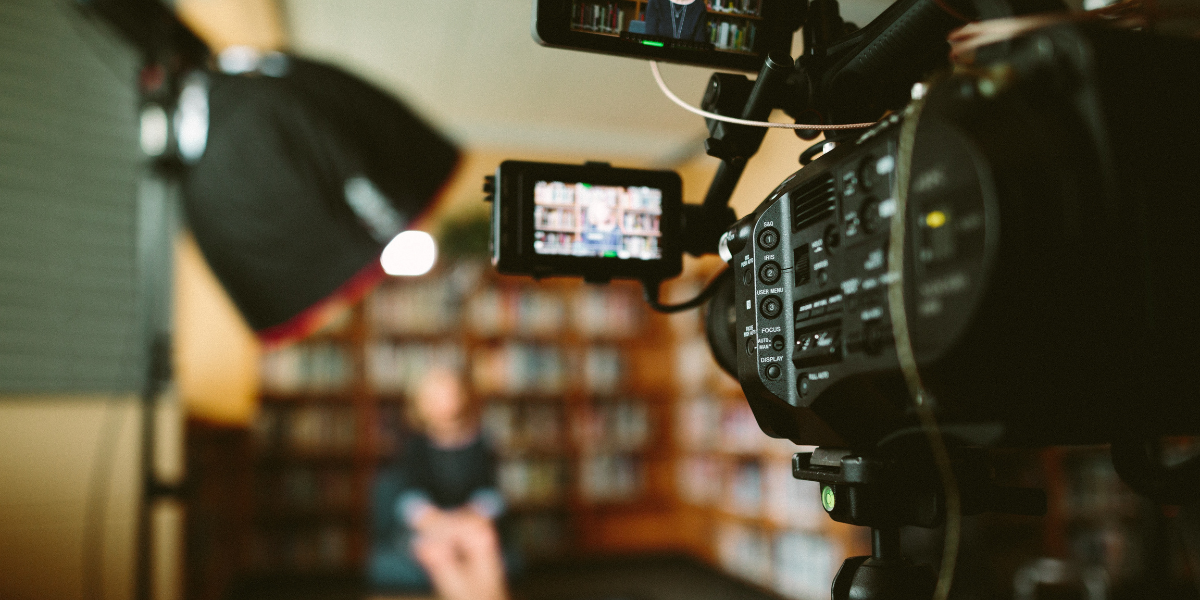 woman sharing her story in front of a bookcase